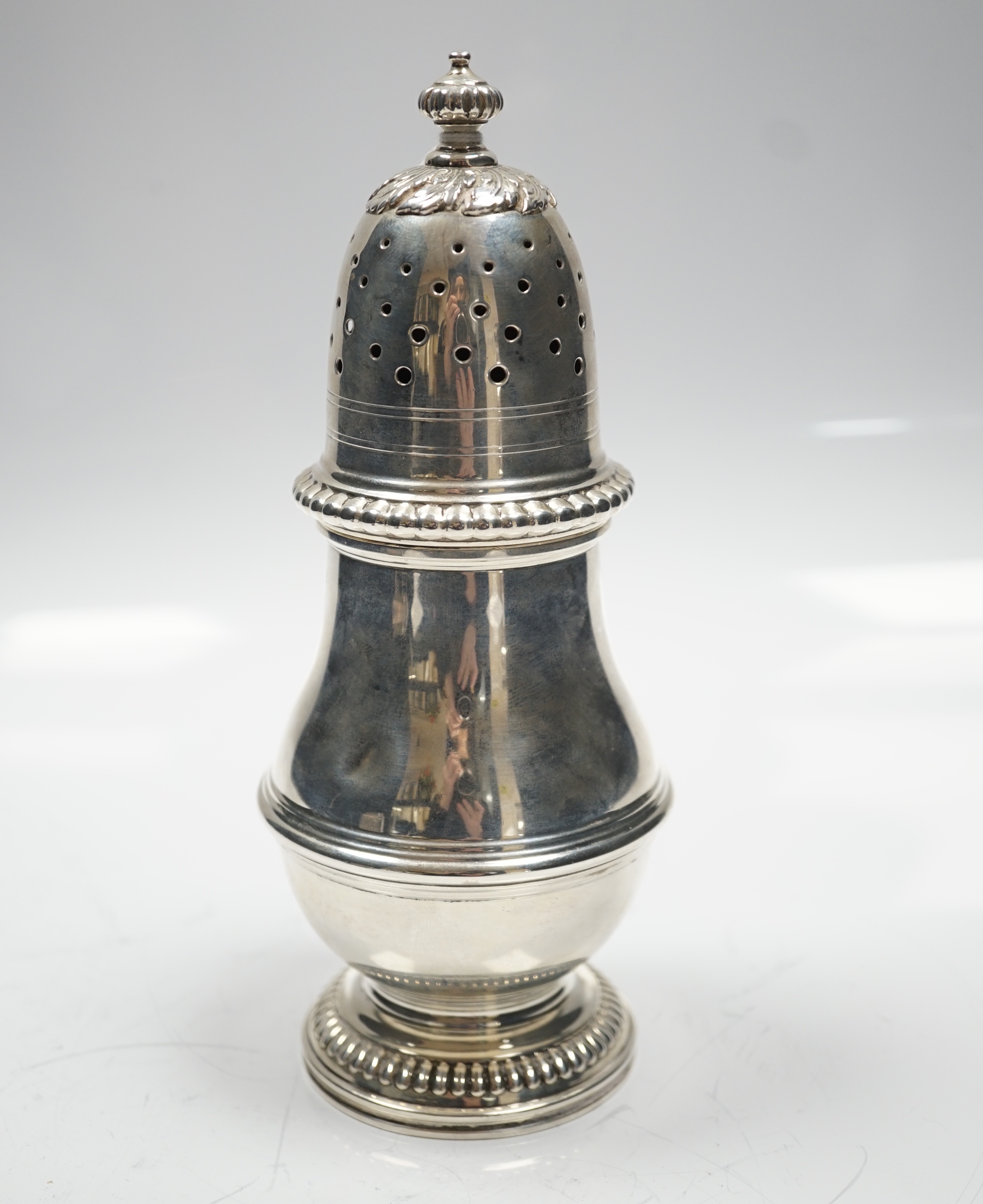 A George V silver baluster sugar caster, Harrod's Ltd, London, 1931, 20.2cm, 9.8oz.